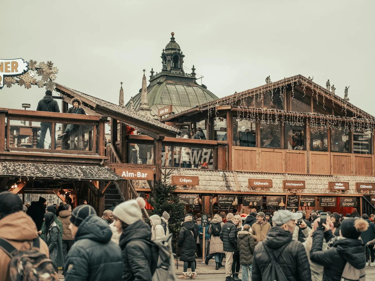 Munich iconic dome architecture at a bustling Christmas market