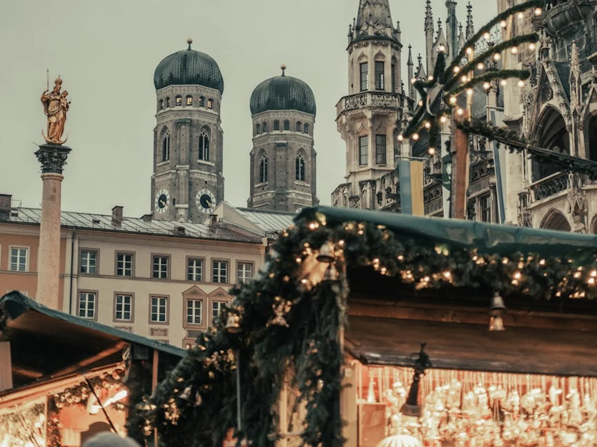 Munich Frauenkirche and Rathaus adorned with Christmas garland during winter