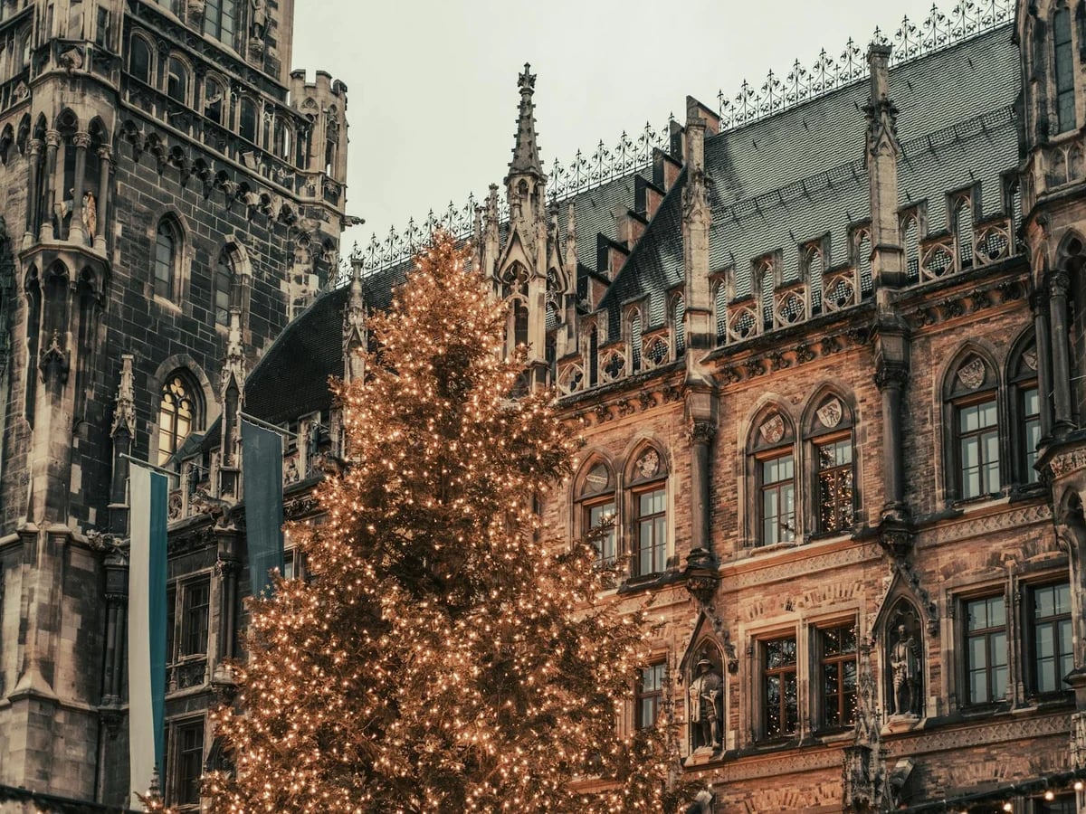 Munich glowing Christmas tree against gothic Rathaus architecture