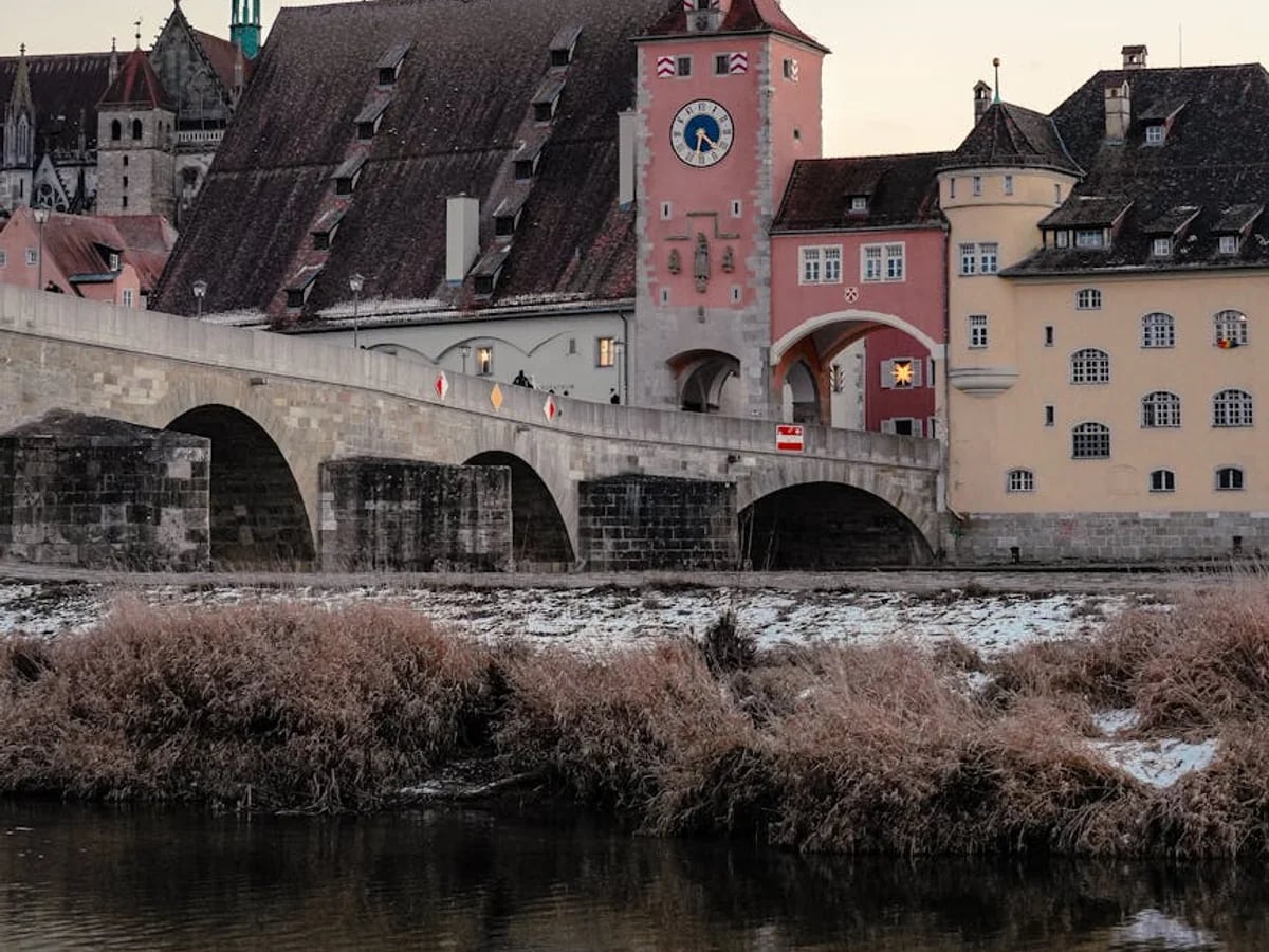 Regensburg winter scene featuring the Stone Bridge and Cathedral's spires