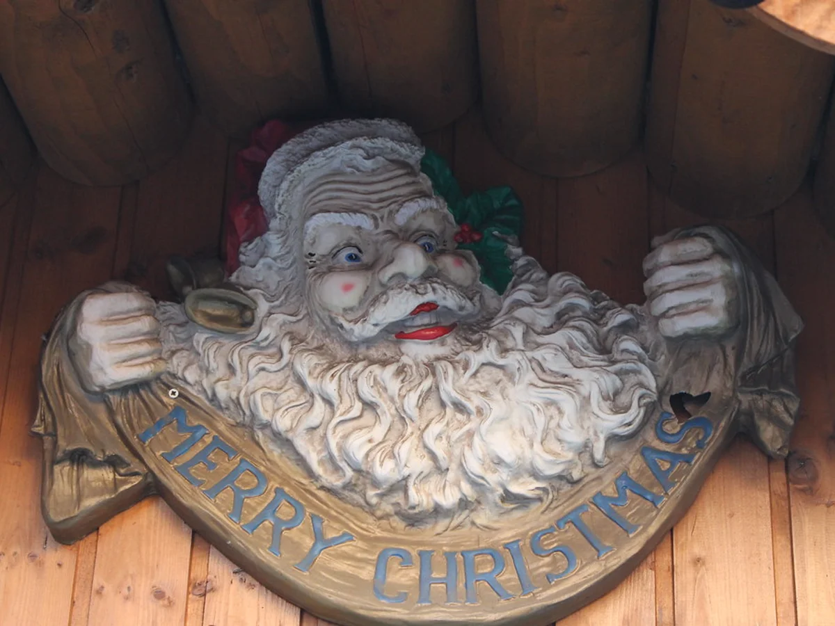 Regensburg Christmas market carved Santa figure at Spitalgarten, warm festive atmosphere