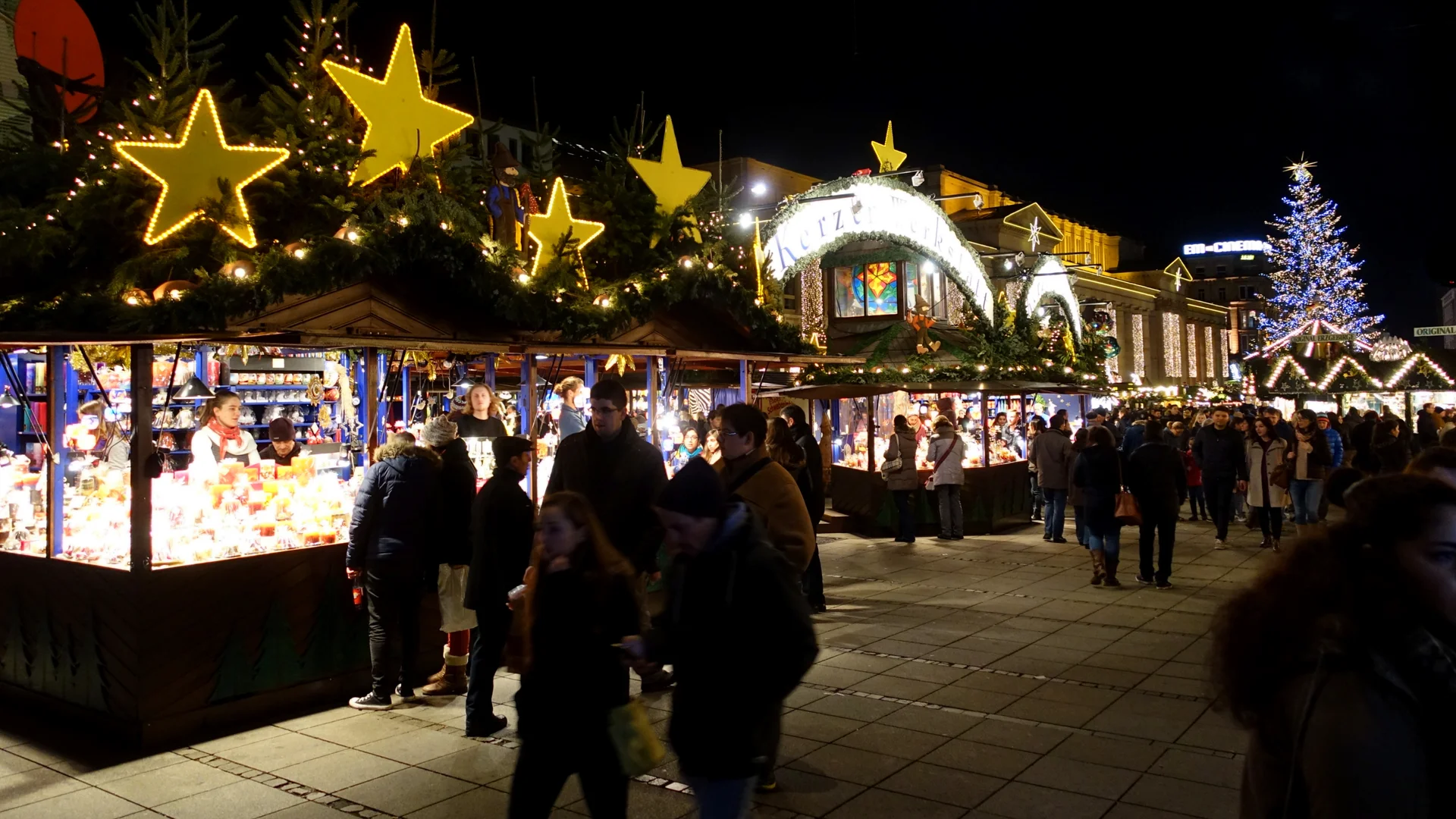 Stuttgart vibrant Christmas market at night with festive yellow stars