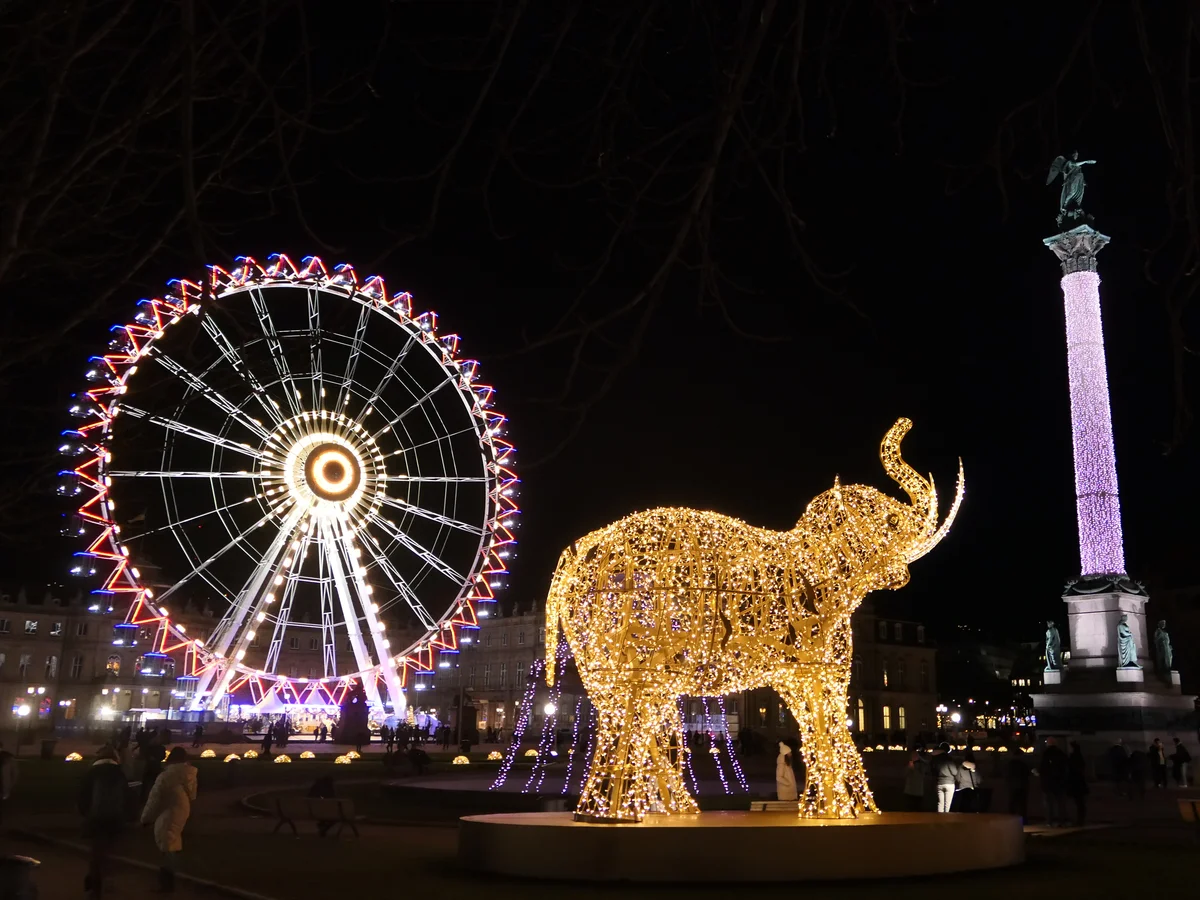 Stuttgart illuminated Ferris wheel and Victory Column at Christmas