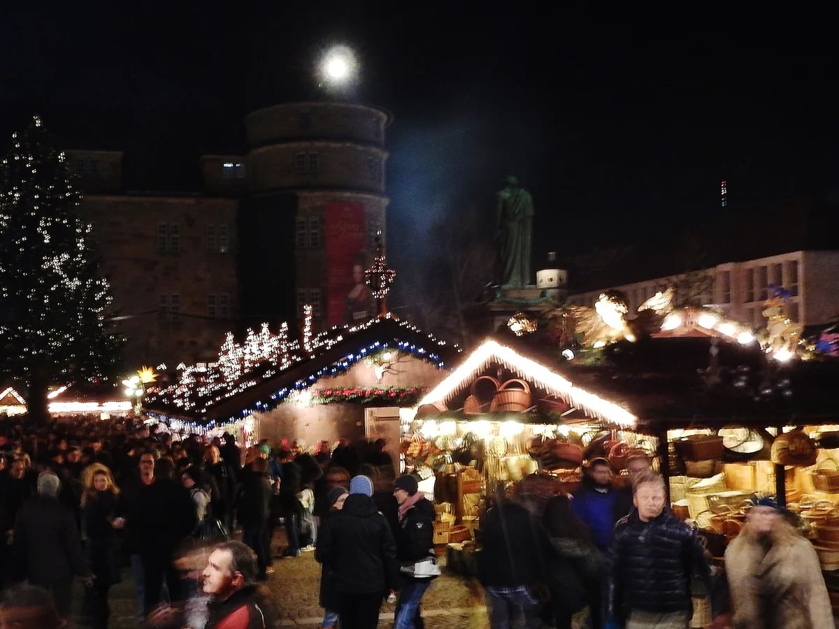 Stuttgart bustling Christmas market scene with festive lights and crowds