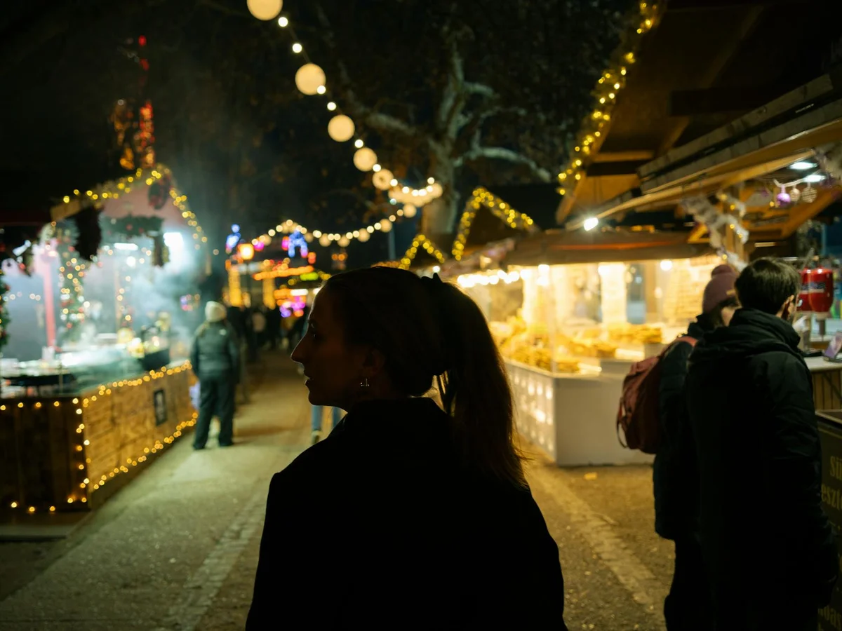 Budapest Christmas market adorned with golden lights at dusk