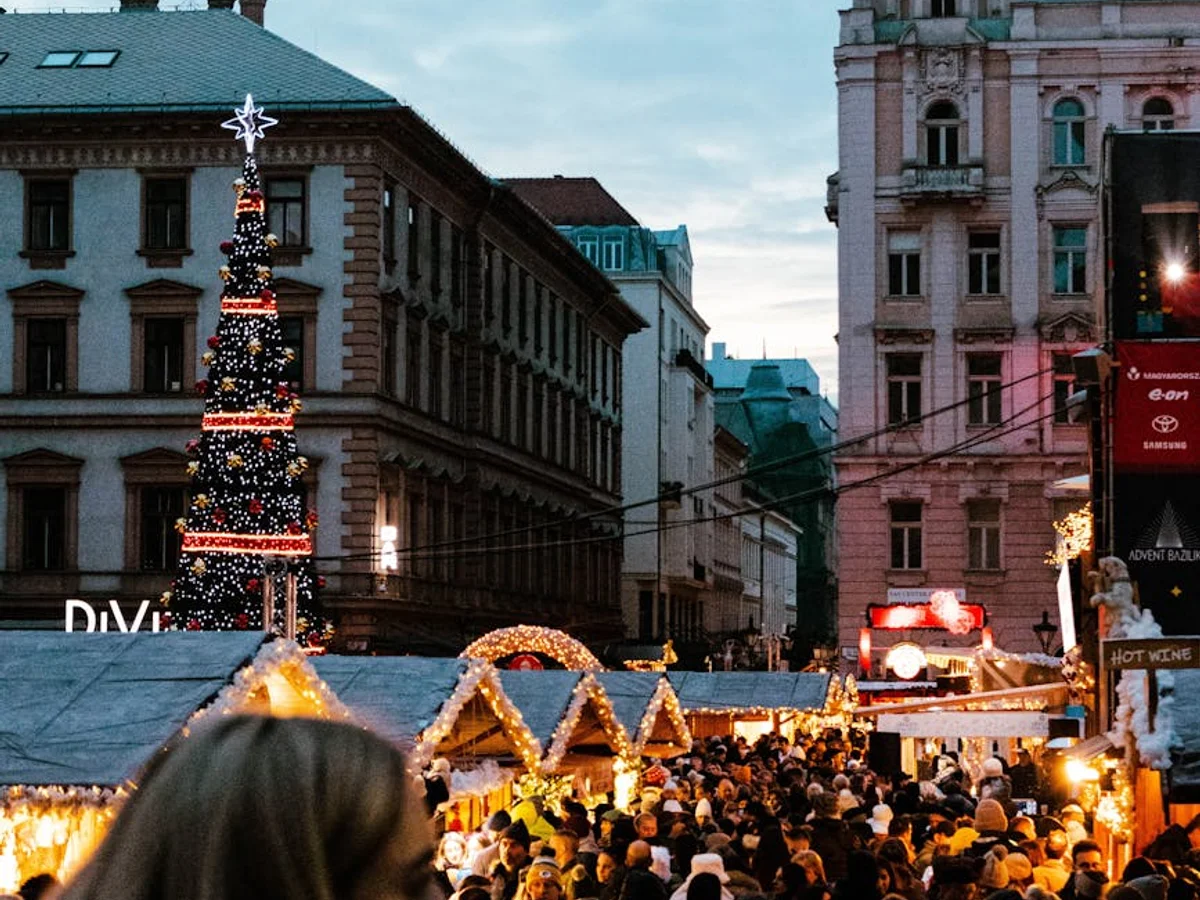 Budapest Christmas market at twilight with festive decorations and Austro-Hungarian architecture