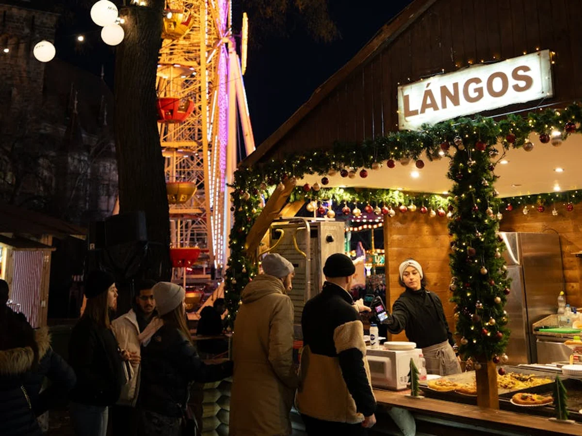 Budapest vibrant Lángos stall at Christmas market during winter blue hour