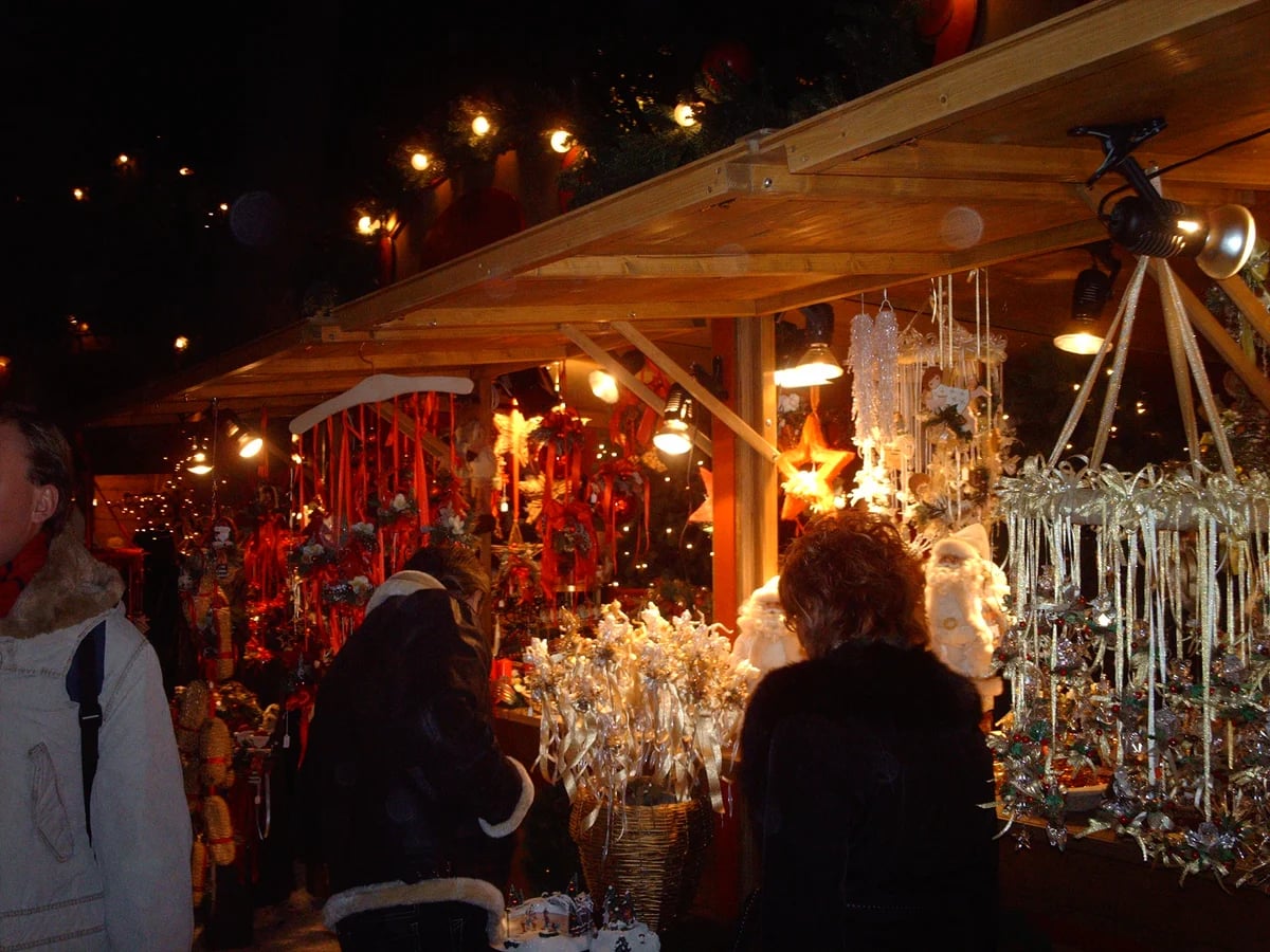 Bolzano traditional wooden market stall glowing with Christmas decorations