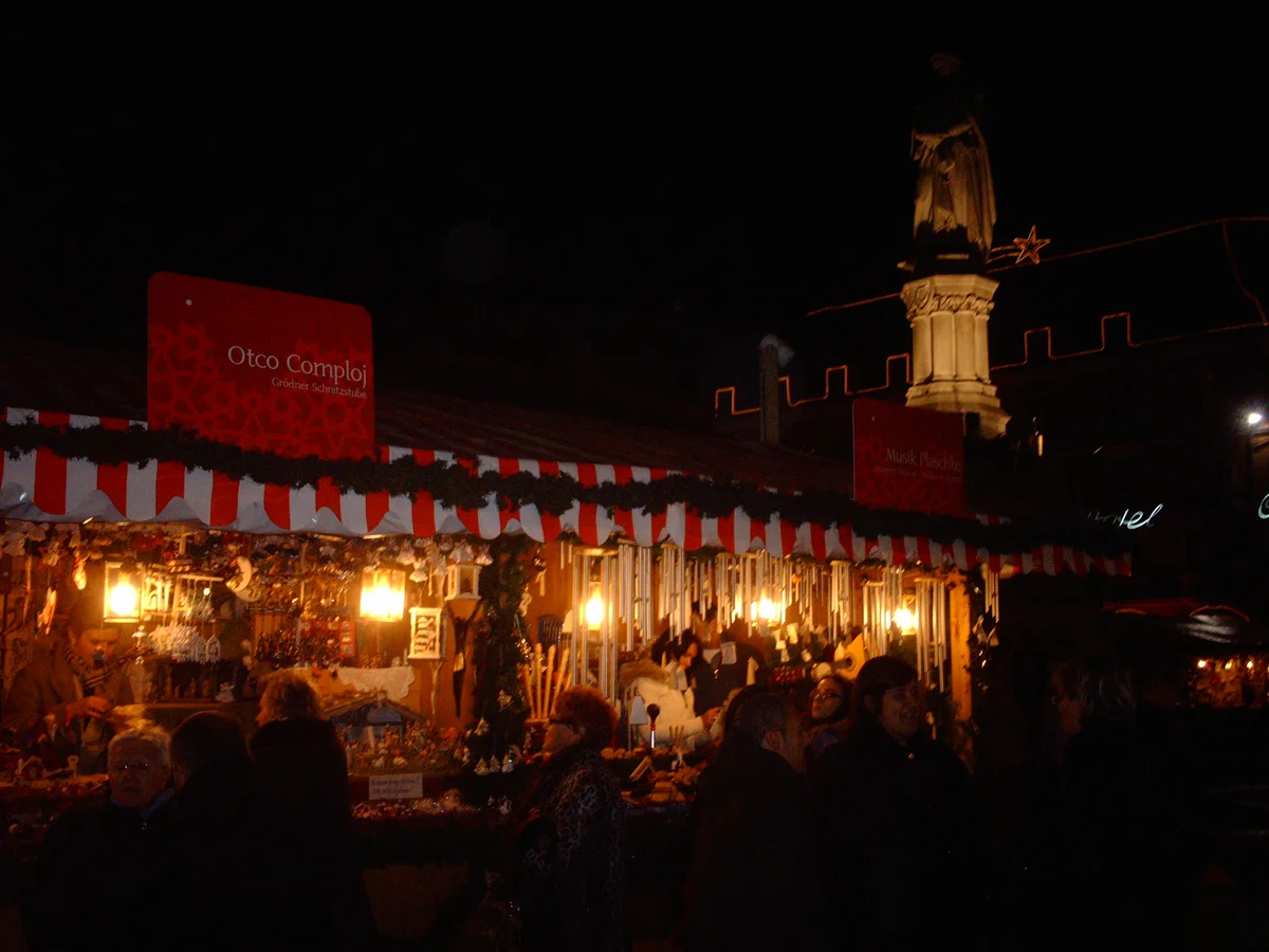 Bolzano illuminated monument during Christmas market evening