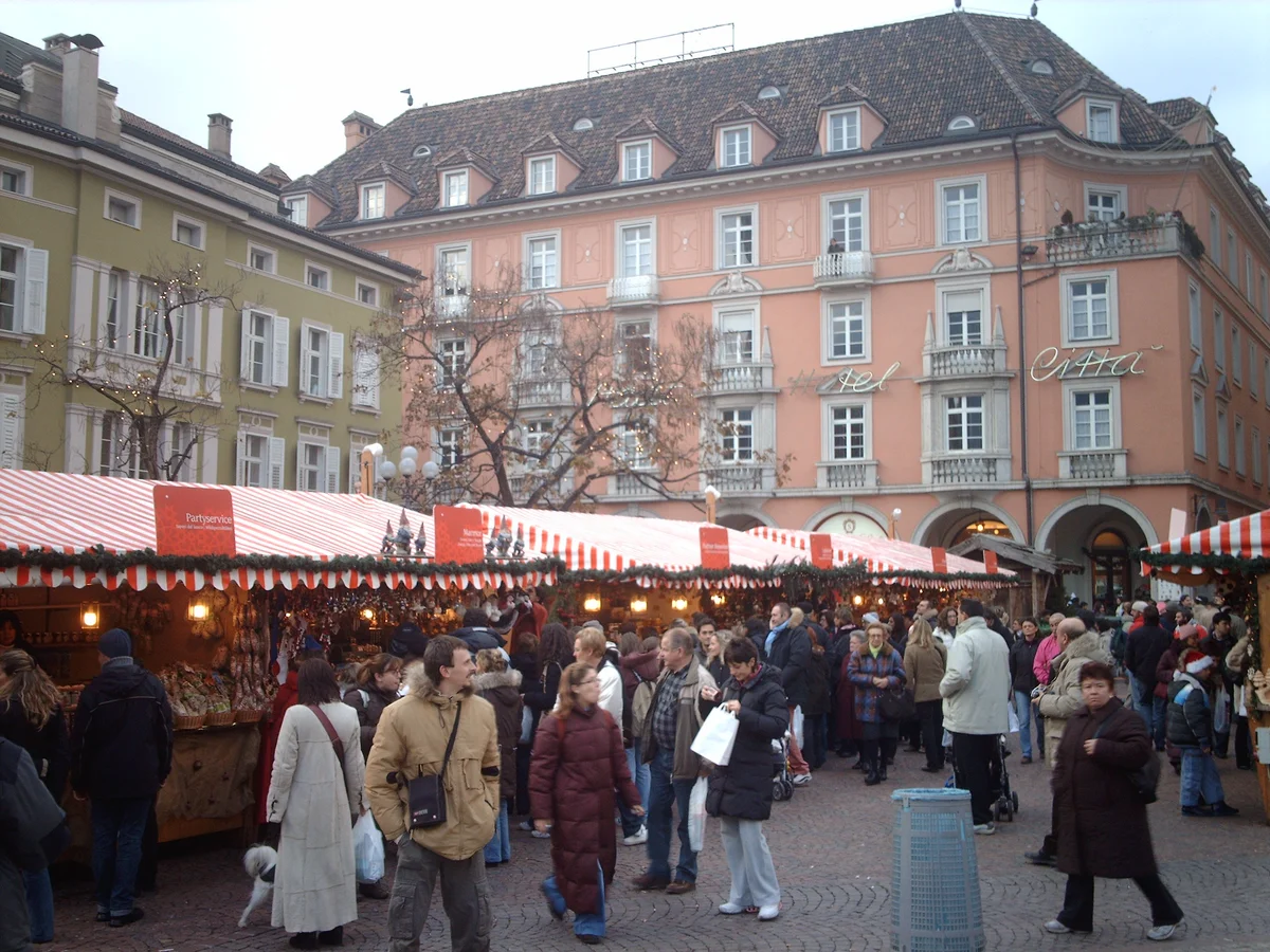 Bolzano bustling Christmas market scene with Renaissance architecture in winter