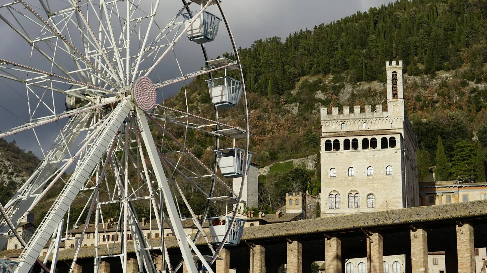 Gubbio medieval Palazzo dei Consoli and ferris wheel during winter festivities