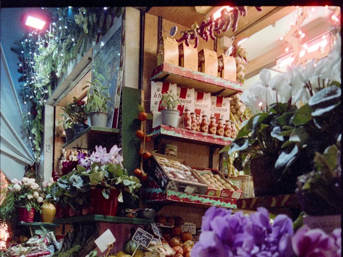 Milan market stall with festive flowers and warm evening lighting