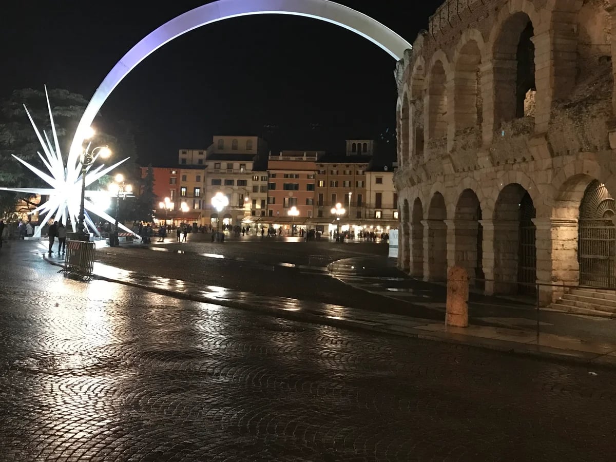Verona Arena and steel star sculpture during Christmas season at blue hour