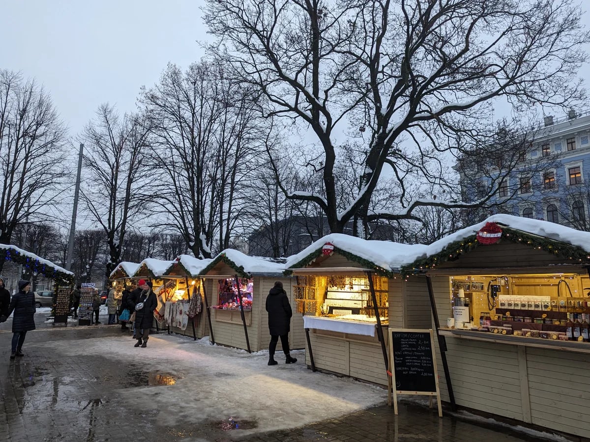 Riga authentic Christmas market scene in winter with snow-dusted stalls