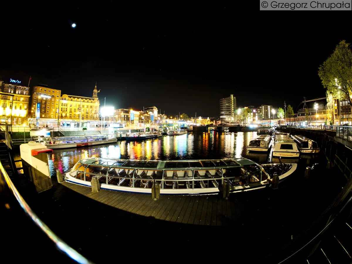 Amsterdam canal scene illuminated at night during winter season