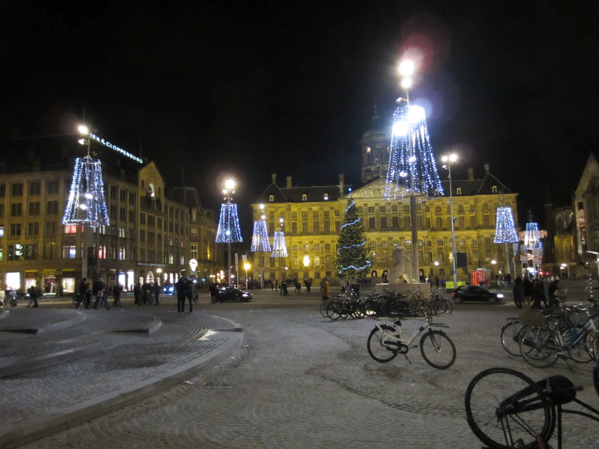 Amsterdam illuminated by blue-lit Christmas trees during winter festivities