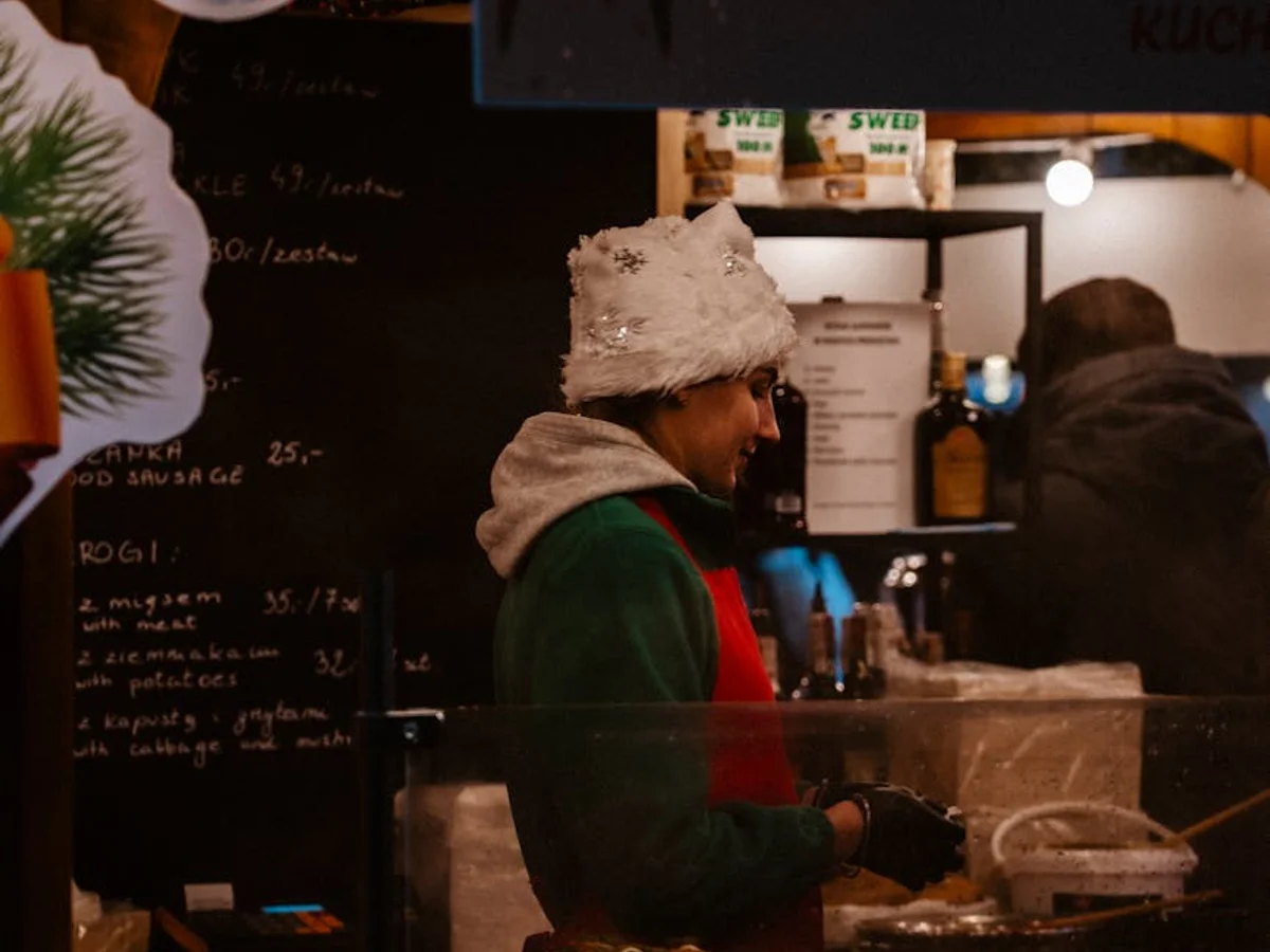 Gdansk evening market vendor amidst festive decorations and warm lighting
