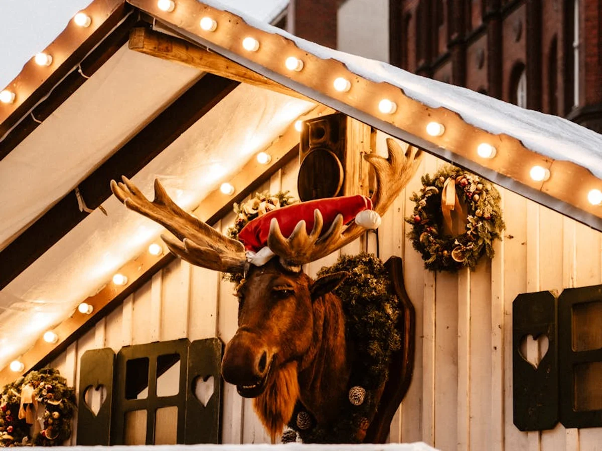 Gdansk festive market stall with whimsical moose head decoration in winter
