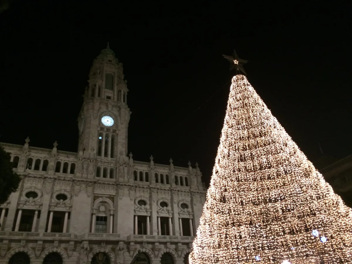 Porto City Hall clock tower with illuminated Christmas tree in winter