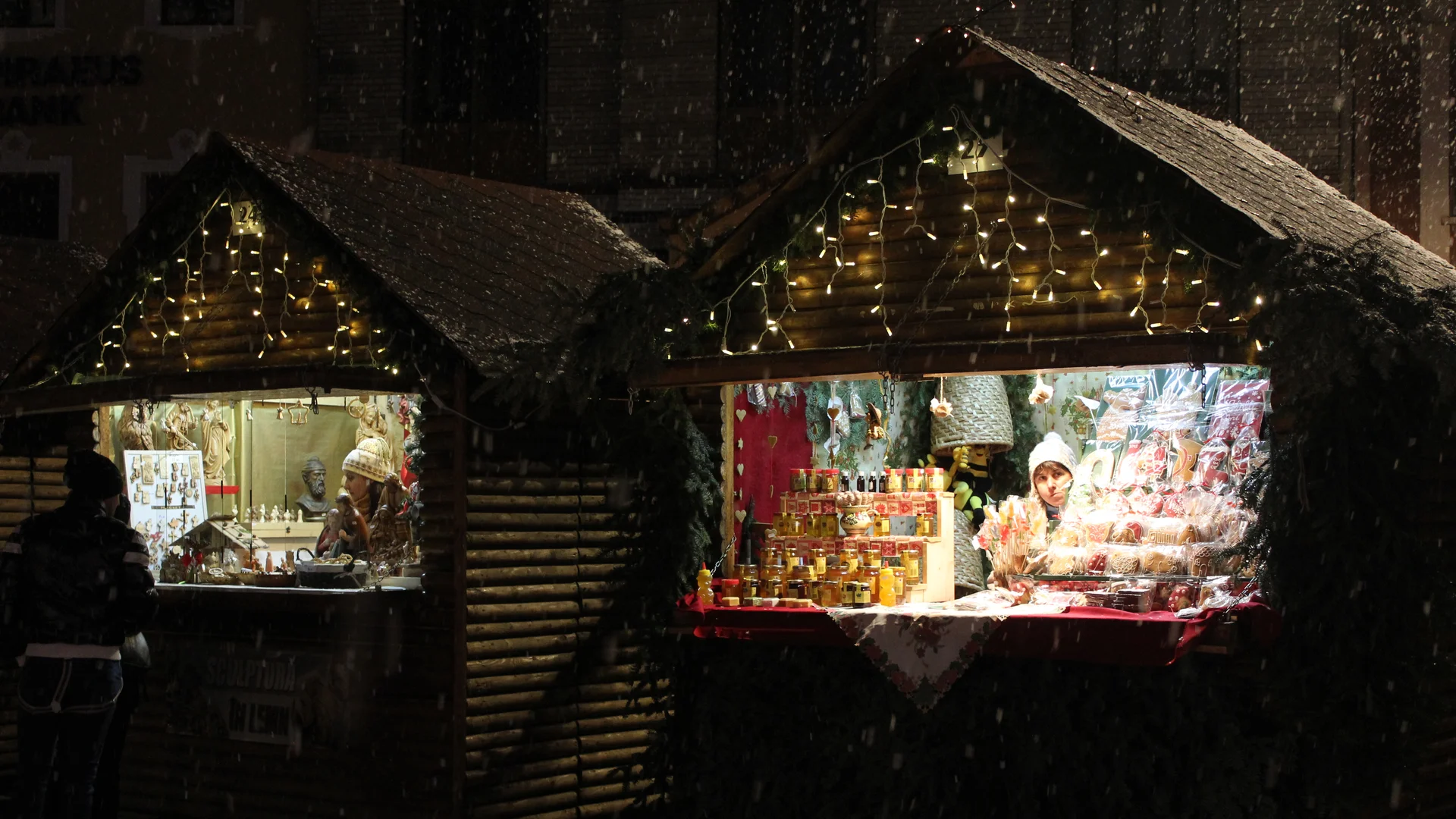 Brasov enchanting Christmas market with glowing stalls in winter evening