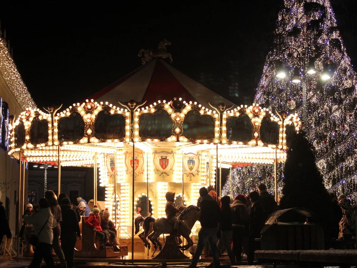 Brasov vintage carousel glowing at Brasov Christmas market in winter night