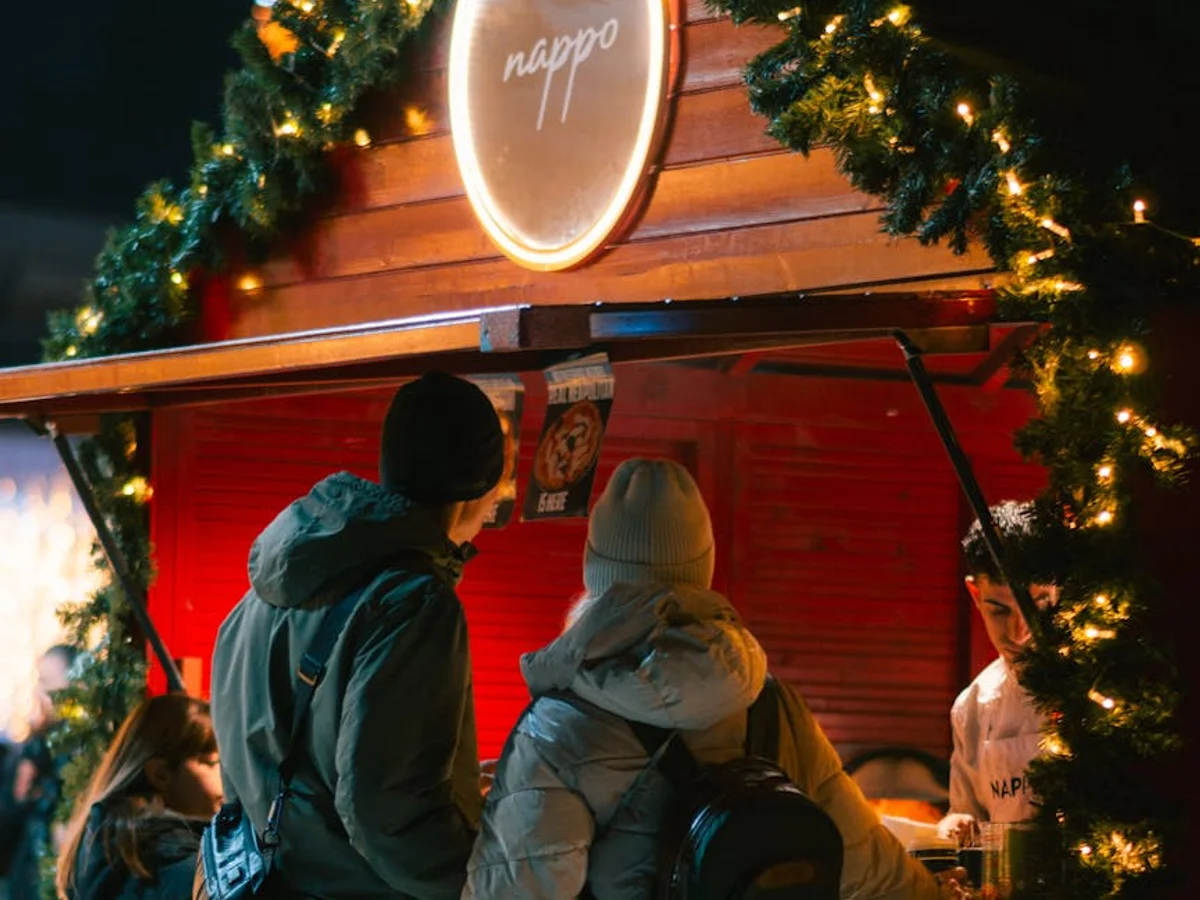 Sibiu Christmas market stall glowing with festive lights in a winter evening