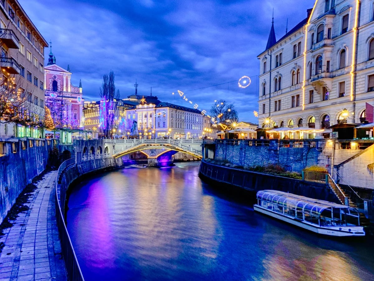 Ljubljana Ljubljanica River illuminated during Christmas season