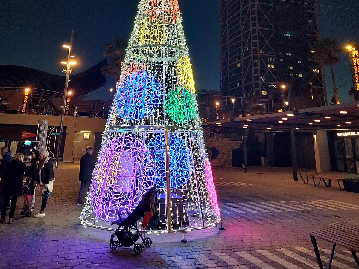 Barcelona vibrant Christmas tree at Port Olímpic during winter evening