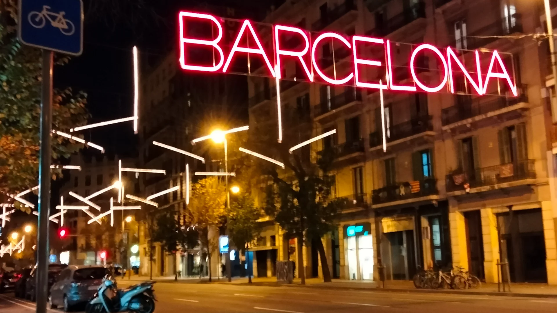 Barcelona neon sign illuminates a quiet street in winter season