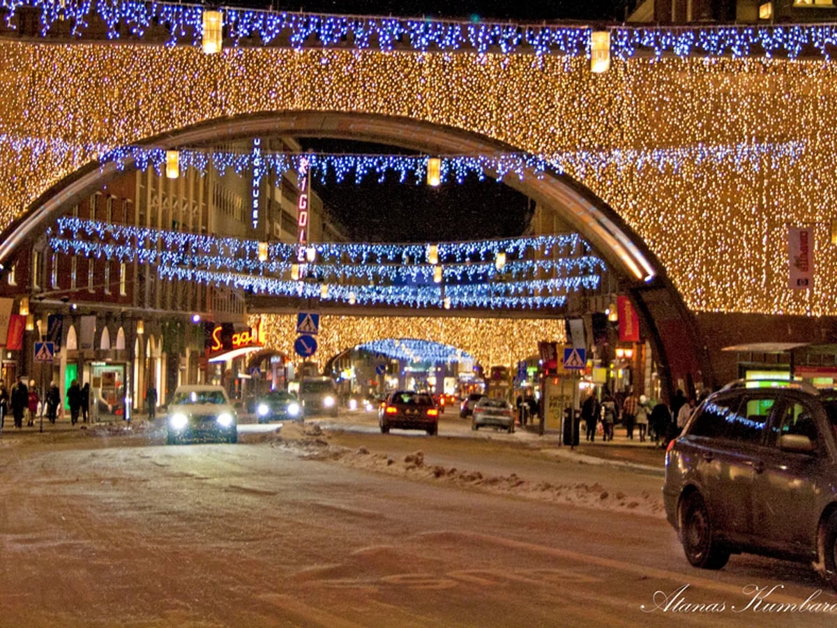 Stockholm iconic red arch illuminated by gold and blue Christmas lights in winter