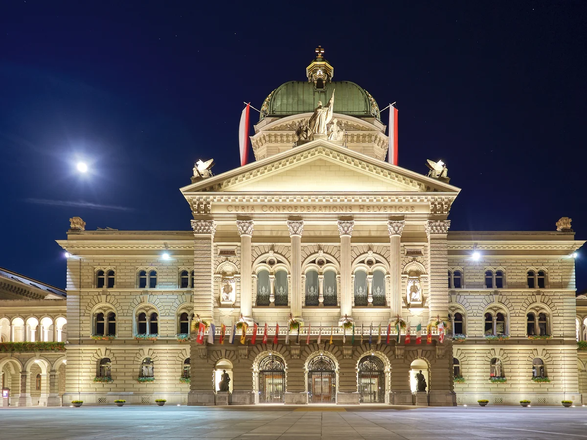 Bern Federal Palace illuminated by moonlight during winter season