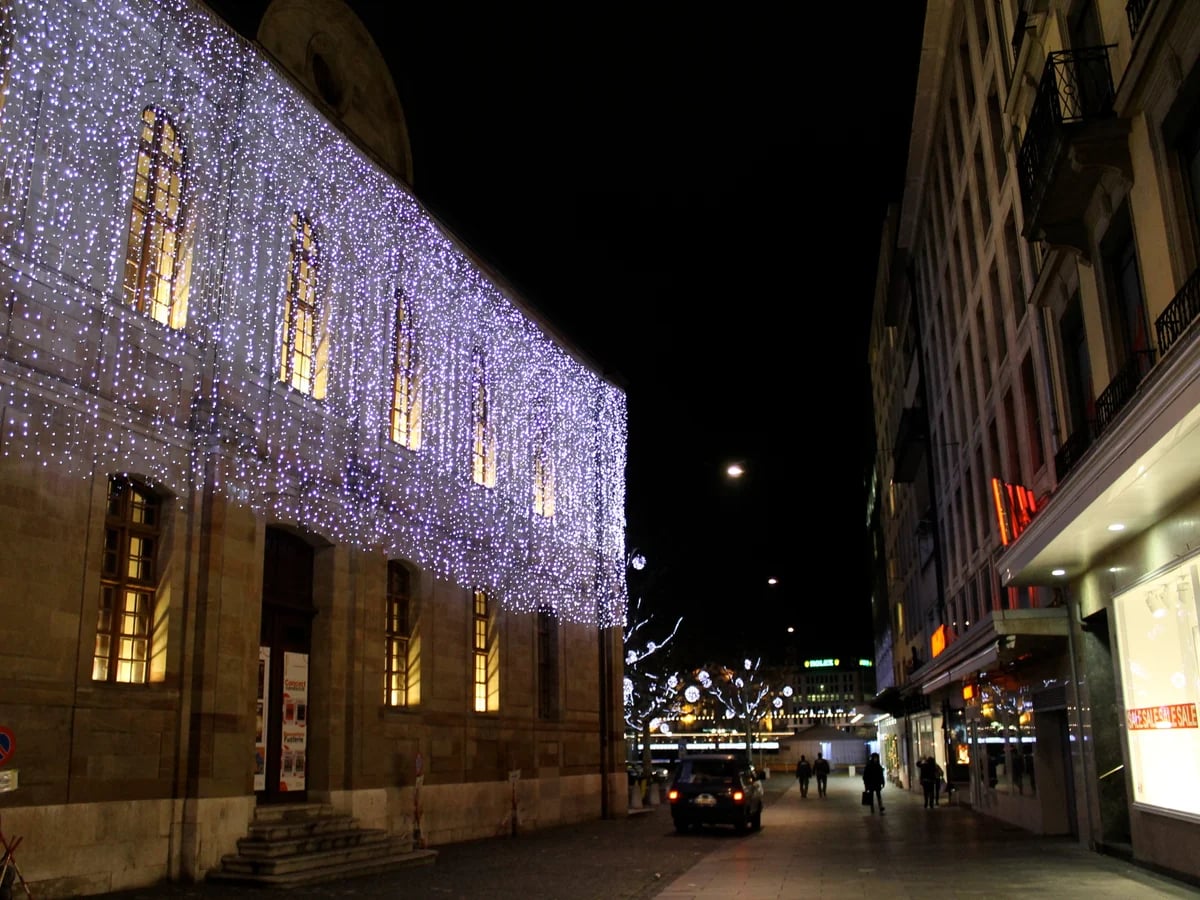 Geneva historic building illuminated in purple lights during winter season