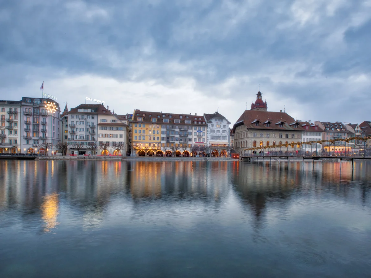 Lucerne waterfront skyline illuminated with Christmas lights during winter twilight