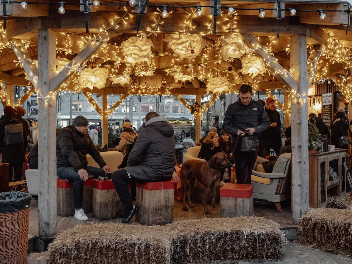 Zurich cozy market seating area adorned with golden lights during winter
