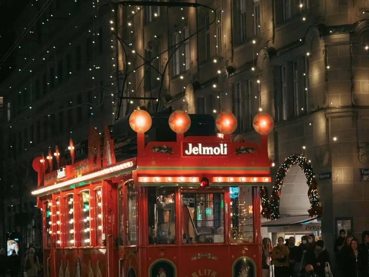 Zurich tram adorned with festive lights in a magical winter evening