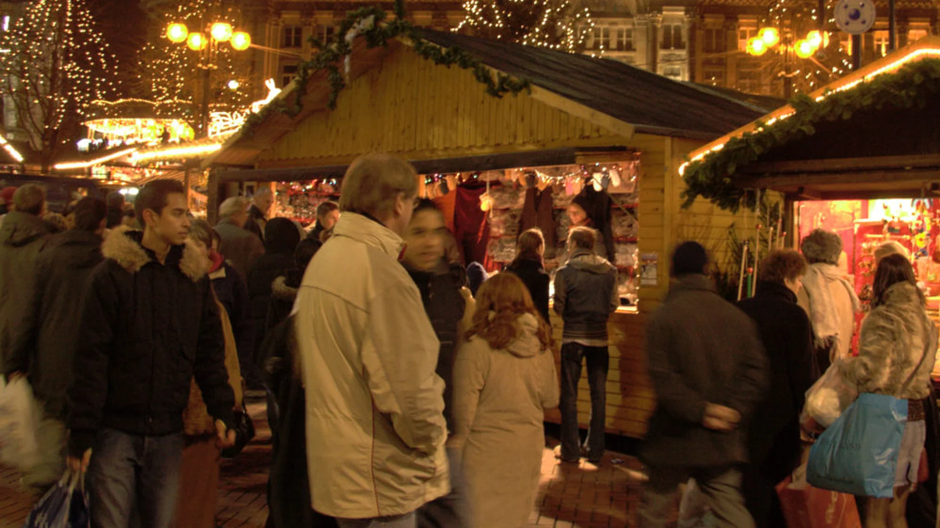 Birmingham Council House glowing during Christmas market at blue hour