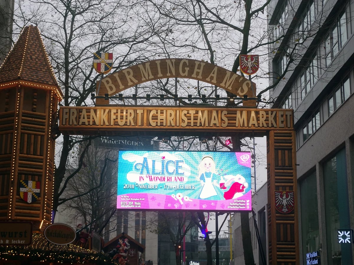 Birmingham Frankfurt Christmas Market entrance with festive lights and wooden architecture