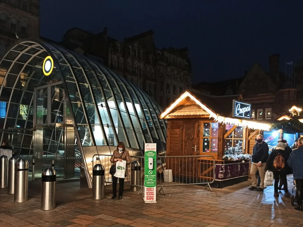 Glasgow Christmas market pavilion glowing warmly at blue hour