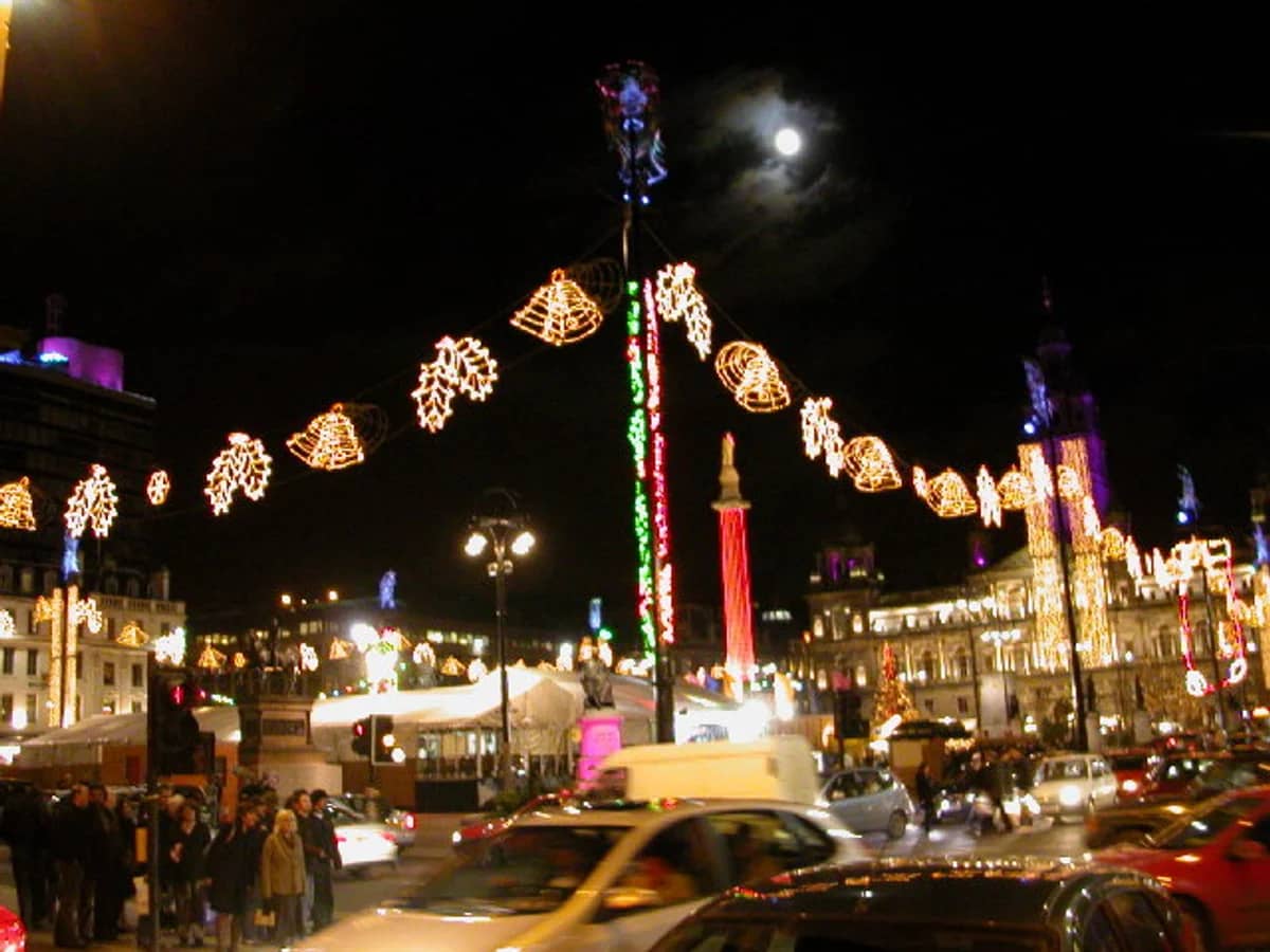 Glasgow George Square adorned with golden Christmas decorations at night