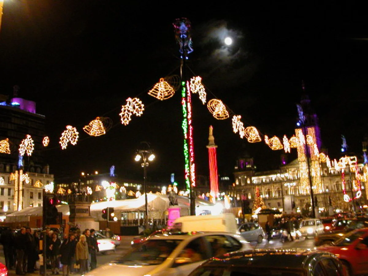 Glasgow George Square adorned with golden Christmas decorations at night