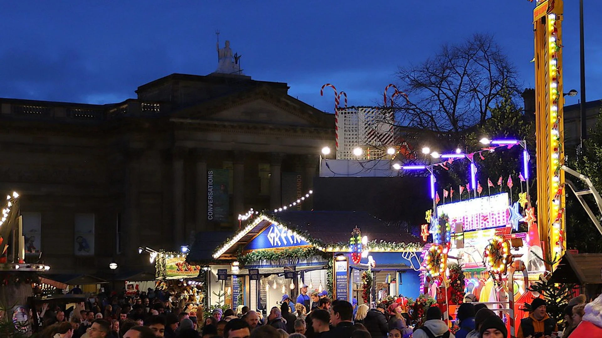 Liverpool Christmas Market bright lights at dusk with St George's Hall backdrop