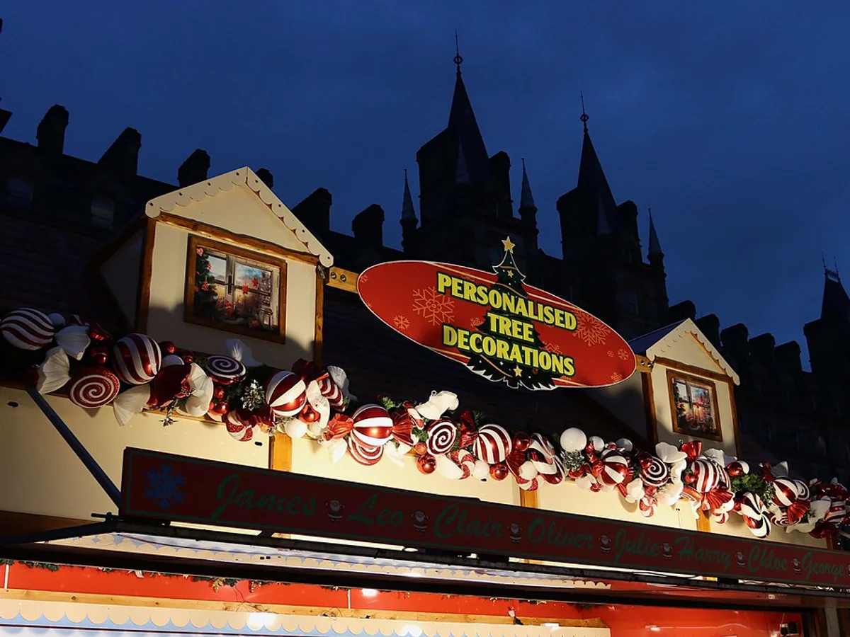 Liverpool Christmas Market festive stall with candy canes at St George's Plateau against twilight sky