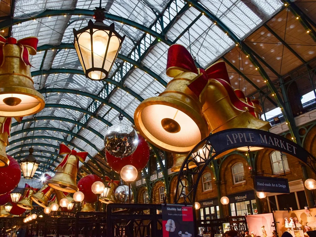 London Covent Garden Market adorned with golden bells and red bows during Christmas season