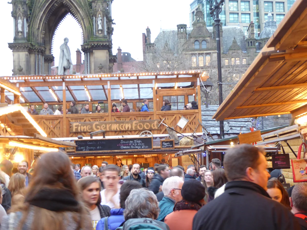 Manchester's festive Albert Square bustling with winter charm and iconic Gothic architecture.