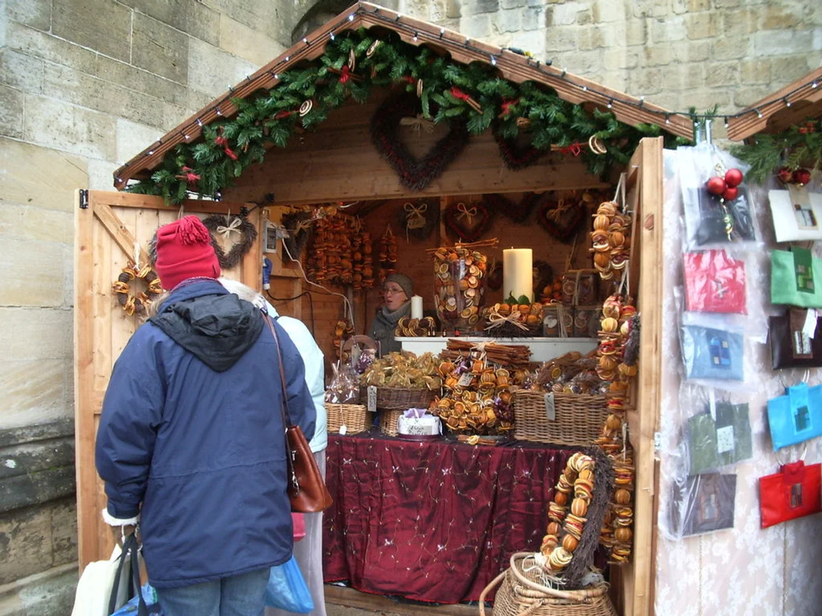 Winchester Cathedral Christmas Market wooden stall with festive ornaments in Winchester's historic atmosphere