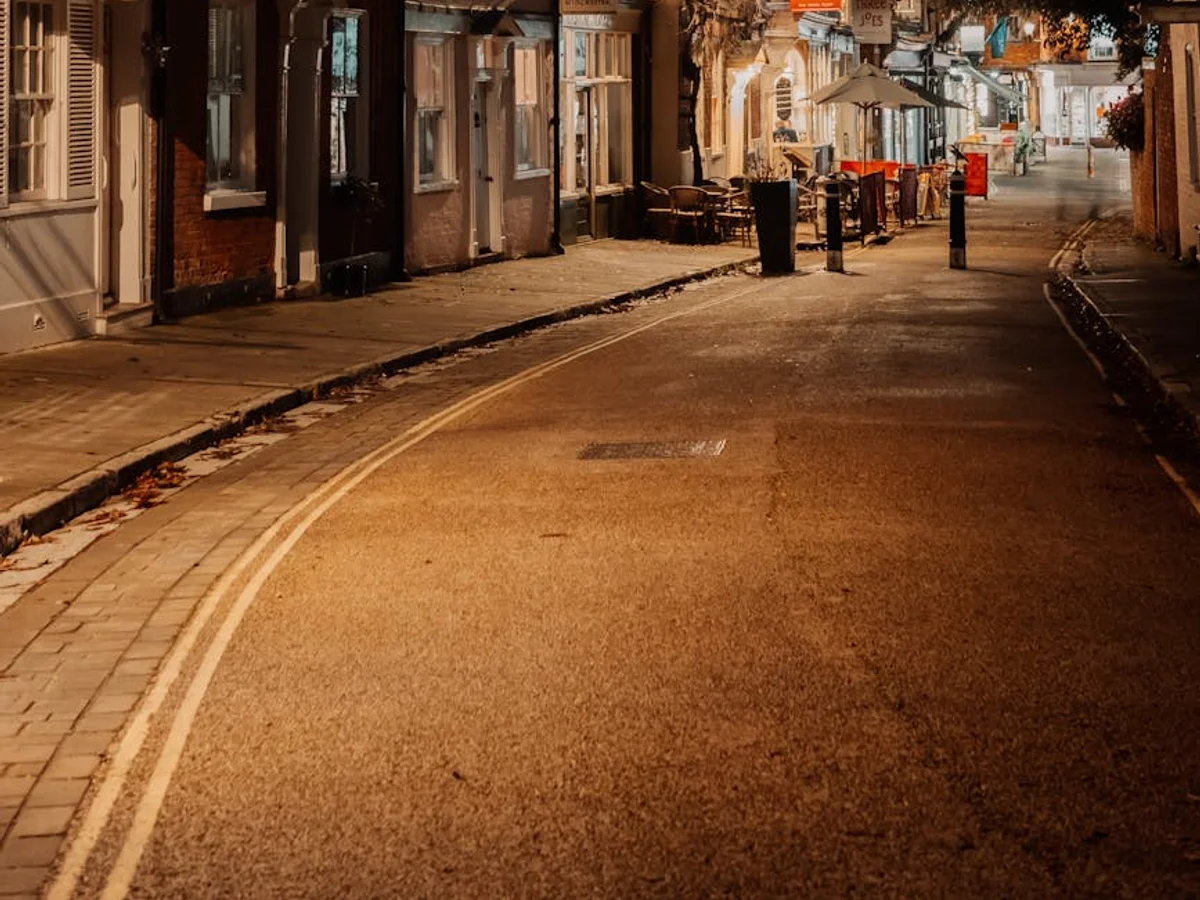 Winchester historic street at dusk, glowing warm shop windows during winter